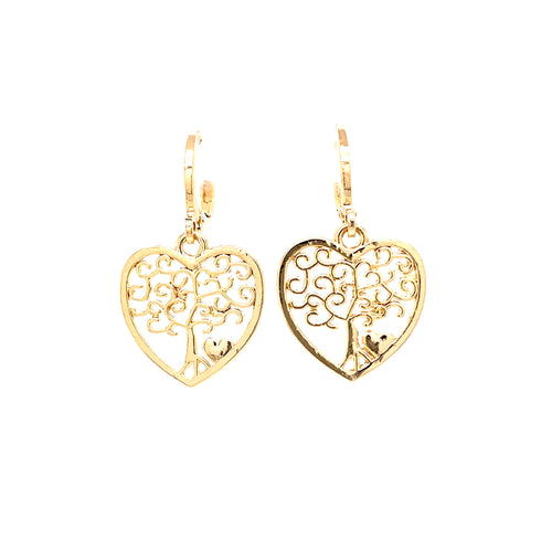 The Tree of Life and Heart Dangle Earrings, crafted in 14k gold-filled material, showcase heart-shaped designs that intricately incorporate elegant swirls and a small heart at the base of each tree, all with a polished finish against a white background.